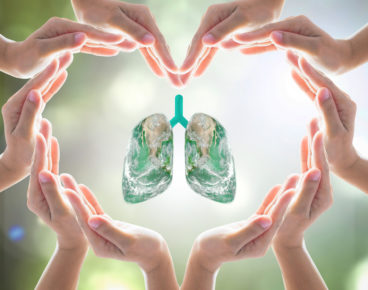 World no tobacco day campaign, lung in heart-shaped hand protection health care design logo concept. Element of this image furnished by NASA